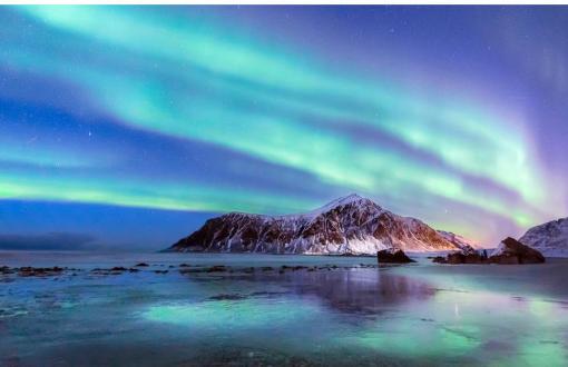 Image of Northern Lights over a snowy landscape